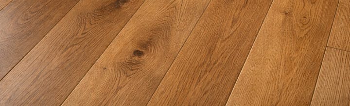 Close-up hardwood flooring pattern with natural oak wood grain texture, warm brown tones, and realistic plank seams.