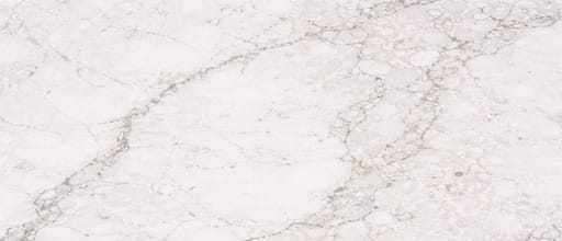 Close-up white quartz countertop surface pattern with soft gray veining and smooth polished engineered stone texture.