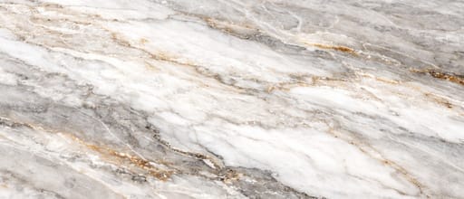 Close-up quartzite countertop surface pattern with natural white and gray stone texture, soft flowing veining, and polished crystalline finish.