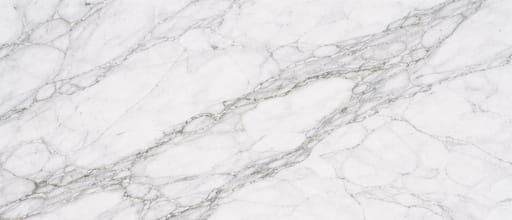 Close-up white marble countertop surface pattern with natural gray veining and polished luxury stone texture.